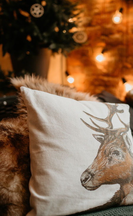 A custom printed cotton linen canvas pillow near a Christmas tree