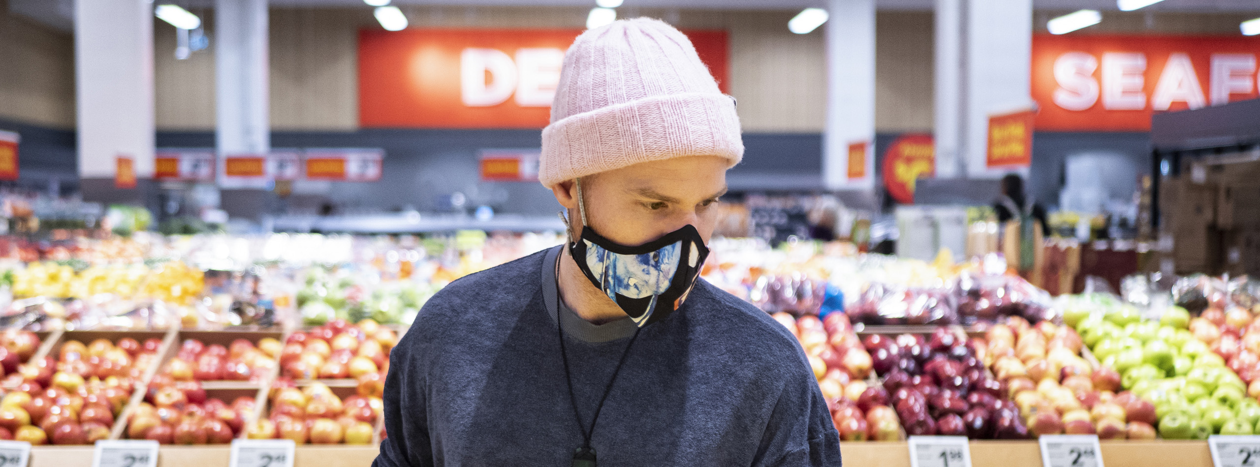 Man with face covering in grocery store