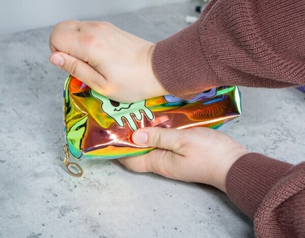 Person applying pressure to sticker