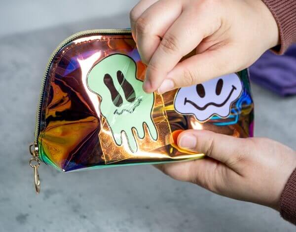 Persone peeling transparent film from sticker